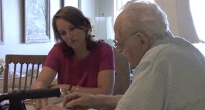 A Maryland guardian helping an older adult with their finances. 